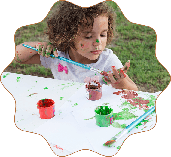Child painting outdoors